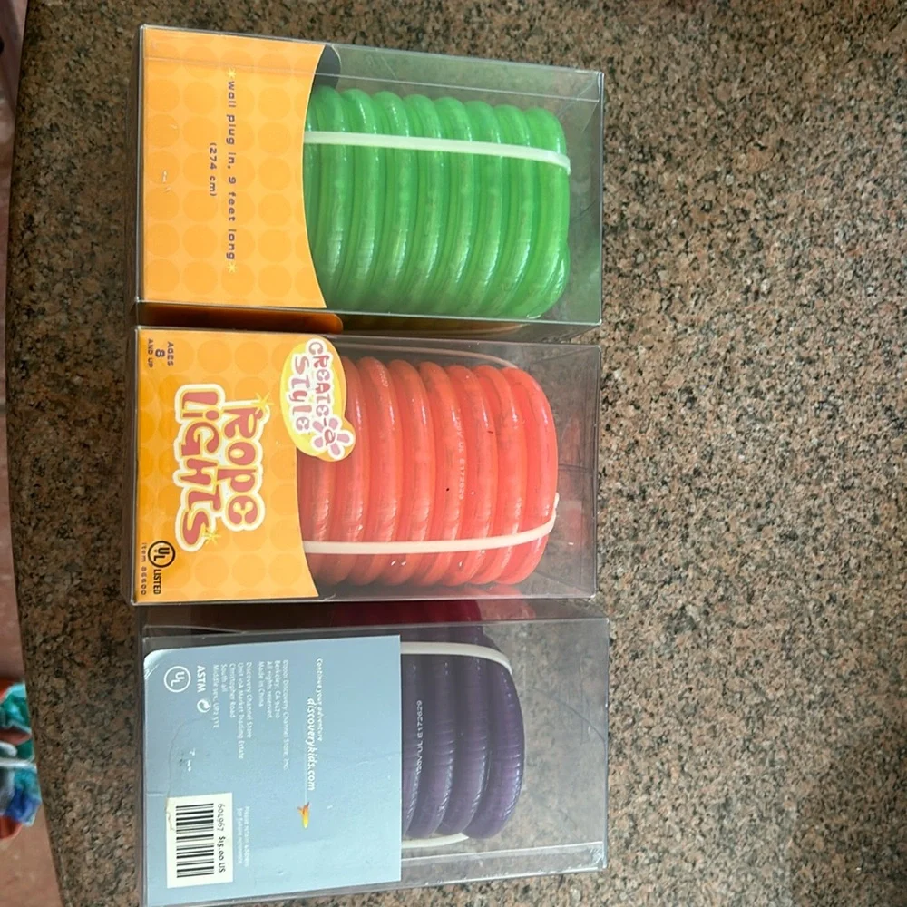 3 boxes of each 9 feet long rope lights, green, red, purple